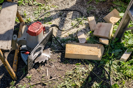 an electric manual circular saw is lying on the ground