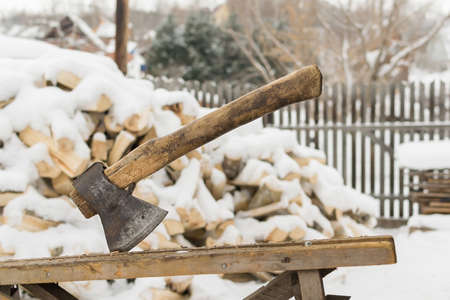an old worn out ax with a wooden handleの写真素材