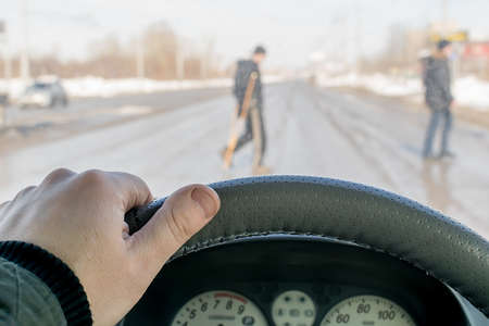 a driver hand on the steering wheel of a carの写真素材