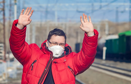 a person, a fugitive, a quarantine violator with his hands upの写真素材