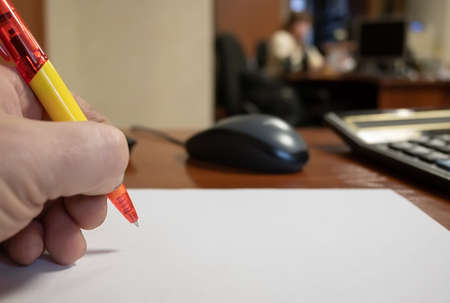 type of writing pen in the hand of an office employeeの写真素材