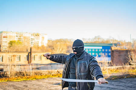 masked bandit trains with a machete in his handsの写真素材