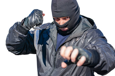isolate, a bandit in a black mask and with a knife prepared to attack