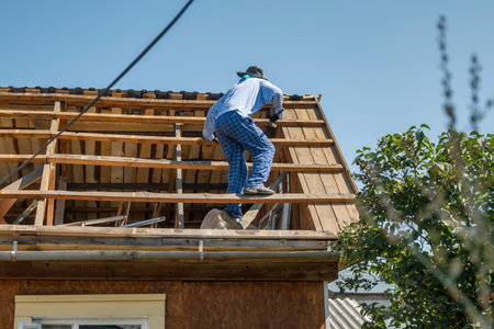 A villager repairs the disassembled roof of a country house