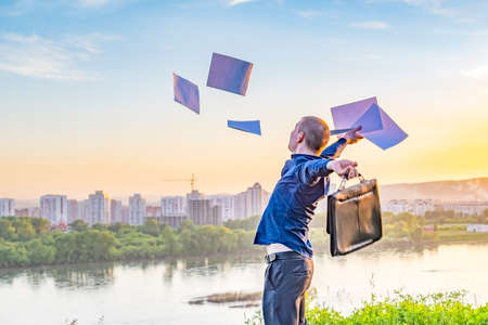 businessman throws documents, papers up in the airの写真素材