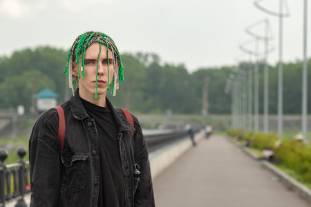 a fashionable guy with pigtails dreadlocks on his head