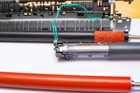 view of the torn film on the surface of the rubber shaft of the spare part from the laser printerの写真素材