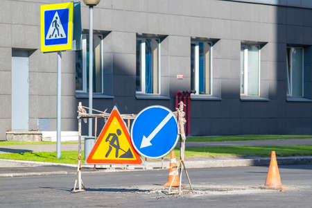 attention, stop, detour, road repair signs installed in the cityの写真素材