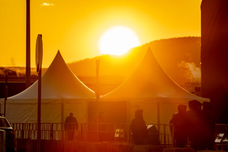 orange, soft, defocused image of a city tent camp for police officersの写真素材