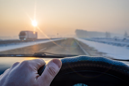 driver hand on the steering wheel of the carの写真素材