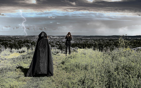 woman in a black raincoat with a hood approaches a young girl