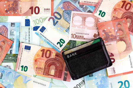 problem with money-cash or cards Black Wallet with credit cards over euro banknotes background. Euro Money Banknotesの写真素材