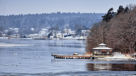 Sweden house in the wintertime. Nature on the shore of the fjord.の写真素材