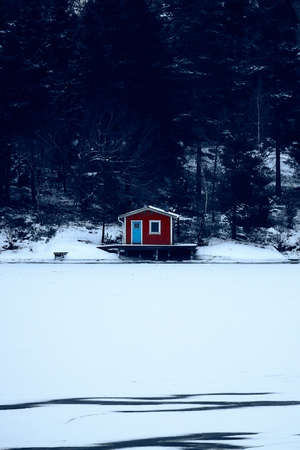 Sweden house in the wintertime. Nature on the shore of the fjord.の写真素材