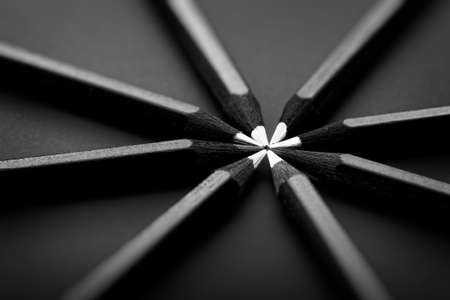 White and black colored pencils. stylish business concept, on black background.の写真素材