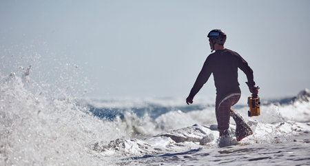 Water surf photographer get footage on a day with large waves. Water sport activity. Atlantic Ocean,...