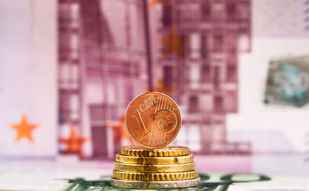 1 Euro cent against 500 Euro banknote, coins and banknotes of the single European currency. Money background.の写真素材