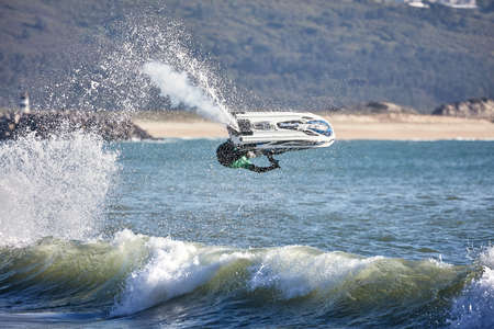 Professional jet ski riders compete at the IFWA World Tour Jet Ski Championship. Contestants perform tricks for judges in the waves. Freeride World Championship IFWA. 27.04.2018, Nazare, Portugalの写真素材