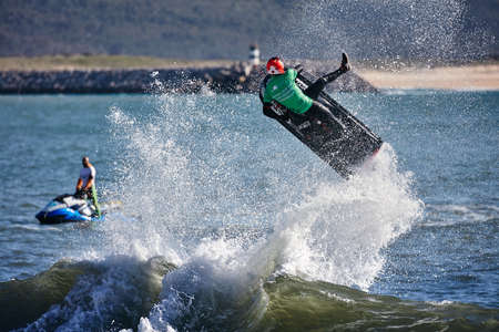 Professional jet ski riders compete at the IFWA World Tour Jet Ski Championship. Contestants perform tricks for judges in the waves. Freeride World Championship IFWA. 27.04.2018, Nazare, Portugalのeditorial素材