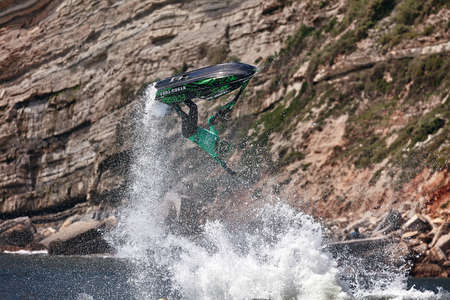 Professional jet ski riders compete at the IFWA World Tour Jet Ski Championship. Contestants perform tricks for judges in the waves. Freeride World Championship IFWA. 27.04.2018, Nazare, Portugalのeditorial素材