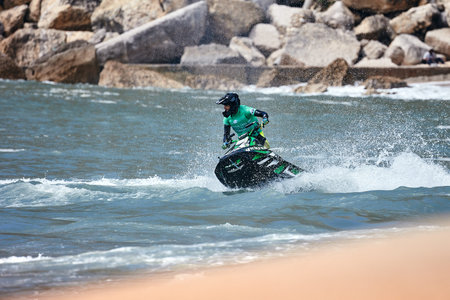 Professional jet ski riders compete at the IFWA World Tour Jet Ski Championship. Contestants perform tricks for judges in the waves. Freeride World Championship IFWA. 27.04.2018, Nazare, Portugalのeditorial素材