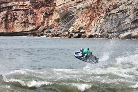Professional jet ski riders compete at the IFWA World Tour Jet Ski Championship. Contestants perform tricks for judges in the waves. Freeride World Championship IFWA. 27.04.2018, Nazare, Portugalのeditorial素材
