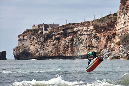 Professional jet ski riders compete at the IFWA World Tour Jet Ski Championship. Contestants perform tricks for judges in the waves. Freeride World Championship IFWA. 27.04.2018, Nazare, Portugalのeditorial素材