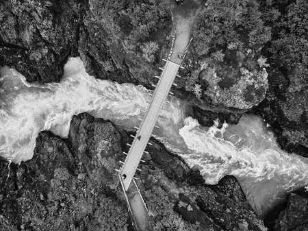 Incredibly beautiful Hraunfossar Waterfall. Lava waterfalls. waterfall flowing down from the lava fields on the canyon of the hvita river, Popular tourist attraction in Iceland. Iceland's clean water.の写真素材