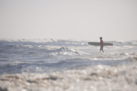 Surfer on the beach. morning on ocean beach. Water sport activity. Atlantic Ocean, Dominican...