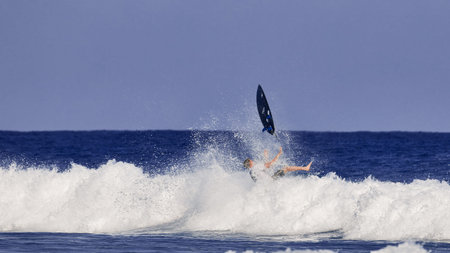 surfing board in the air After a surfer falls into the water. Water sport activity, surfboard in the air.のeditorial素材