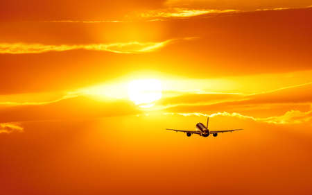 Plane is taking off at sunsetの写真素材
