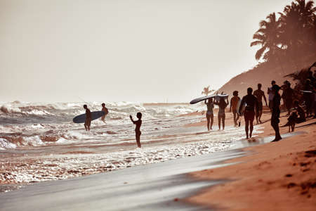 Surfers beach. Surfer on an ocean beach. Water sport activity. Atlantic Ocean, Dominican Republic. 12/29/2016.のeditorial素材