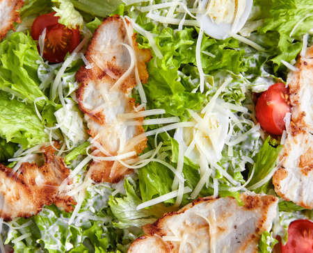 Delicious and healthy food. salad with meat, cheese, eggs, greens and tomatoes.の写真素材