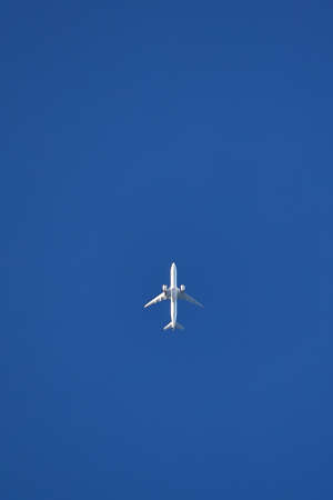 Plane in the clear sky. bottom view.の写真素材