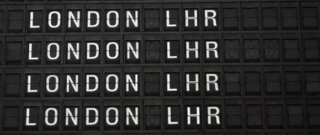 Departures board at the airport. Flight information mechanical timetable. Split flap mechanical...