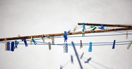colored clothespins hanging on a rope. rope for drying clothes.の写真素材