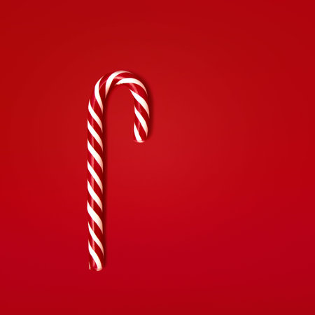 Caramel spiral sticks. red and caramel spiral sticks on the red backgroundの写真素材