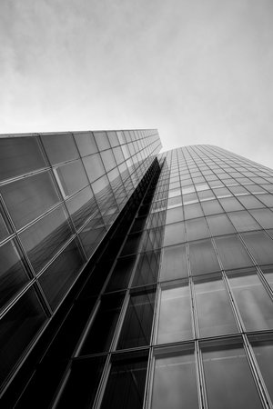 A modern office building with clear blue sky. Business office skyscrapers, looking up at high-rise...