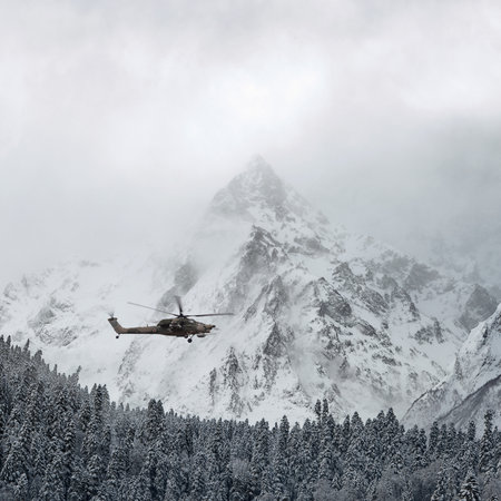 Combat helicopter over the winter mountainsの写真素材
