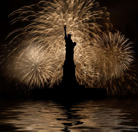 Statue of Liberty on the background of golden fireworksの写真素材