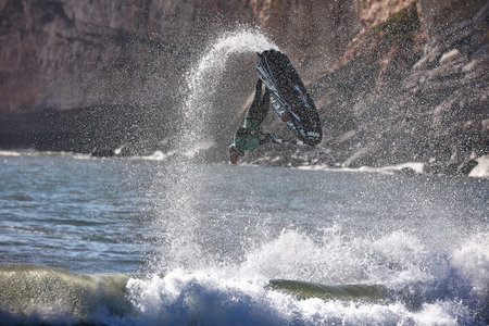 Professional jet ski riders compete at the IFWA World Tour Jet Ski Championship. Contestants perform tricks for judges in the waves. Freeride World Championship IFWA. 04/27/2018, Nazare, Portugalのeditorial素材