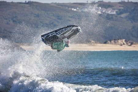 Professional jet ski riders compete at the IFWA World Tour Jet Ski Championship. Contestants perform tricks for judges in the waves. Freeride World Championship IFWA. 04/27/2018, Nazare, Portugalのeditorial素材