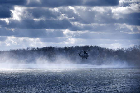helicopter hovered over the water. Transport helicopter Mi-26 T2 in flight (on the codification of NATO: Halo) is a heavy multipurpose transport helicopter. Largest transport helicopter. 01.11.2017, Rostov Region, Russiaのeditorial素材