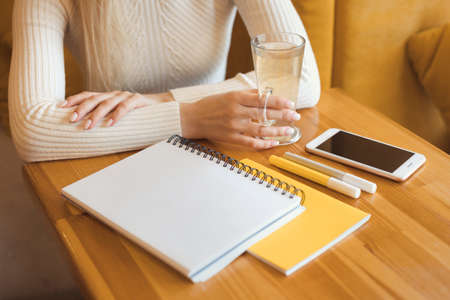 Close up details of young student girl sitting in cafe and studyingの写真素材
