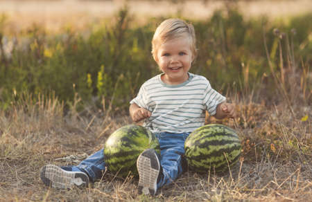 Summer fun vacation of little cute boy with watermelonの写真素材