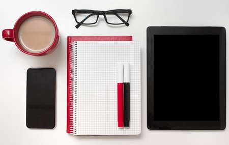 Top view of office work place in white, black and red colors.の写真素材
