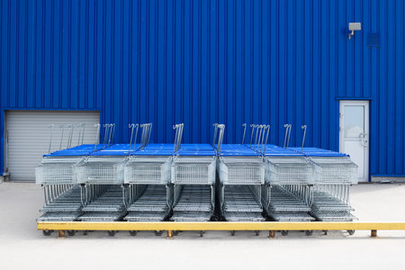 Many empty metal carts for shopping in a supermarket parking. Store closed at lockdown due to coronavirus pandemicの写真素材