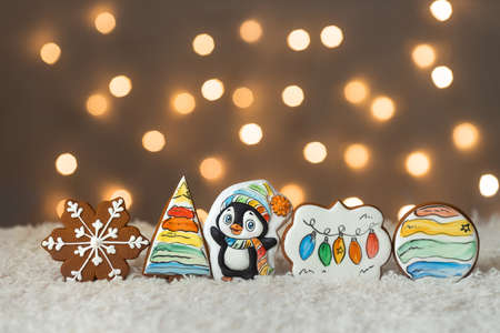 Christmas cute set of cinnamon gingerbread cookies for kids on background of garlands warm bokeh lightsの写真素材
