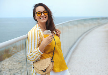 Portrait of beautiful and happy positive milenniall woman 30-35 years old in trendy clothes on vacationの写真素材
