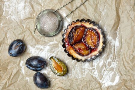 Baking with plums on the parchment. Confectionery productの写真素材